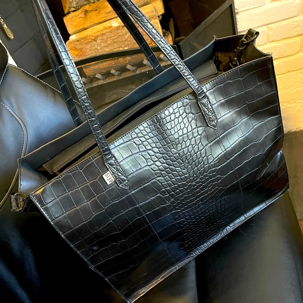 Black beis work bag. Lots of room for everything. Hooks onto luggage handles.